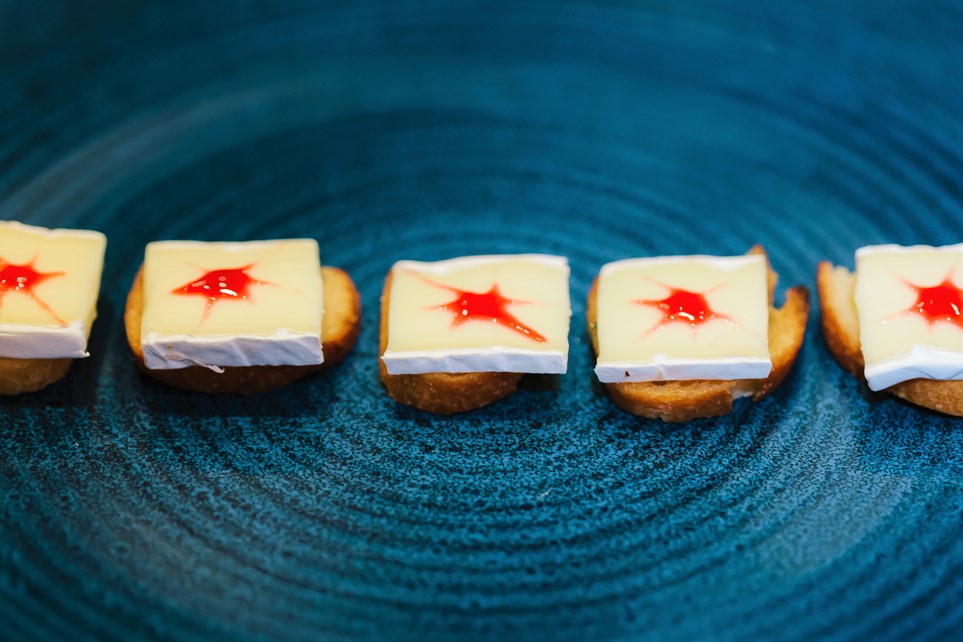 colourful red and white canapes on a black plate from private chef tom burney of hong kong personal chef