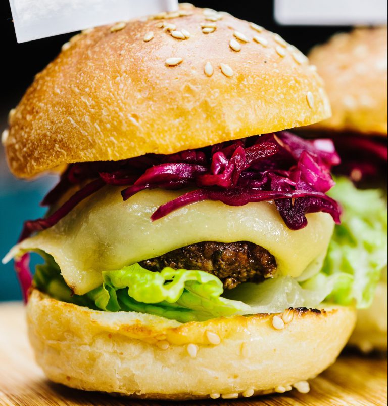 close up of BBQ beef burger with cheese and red cabbage